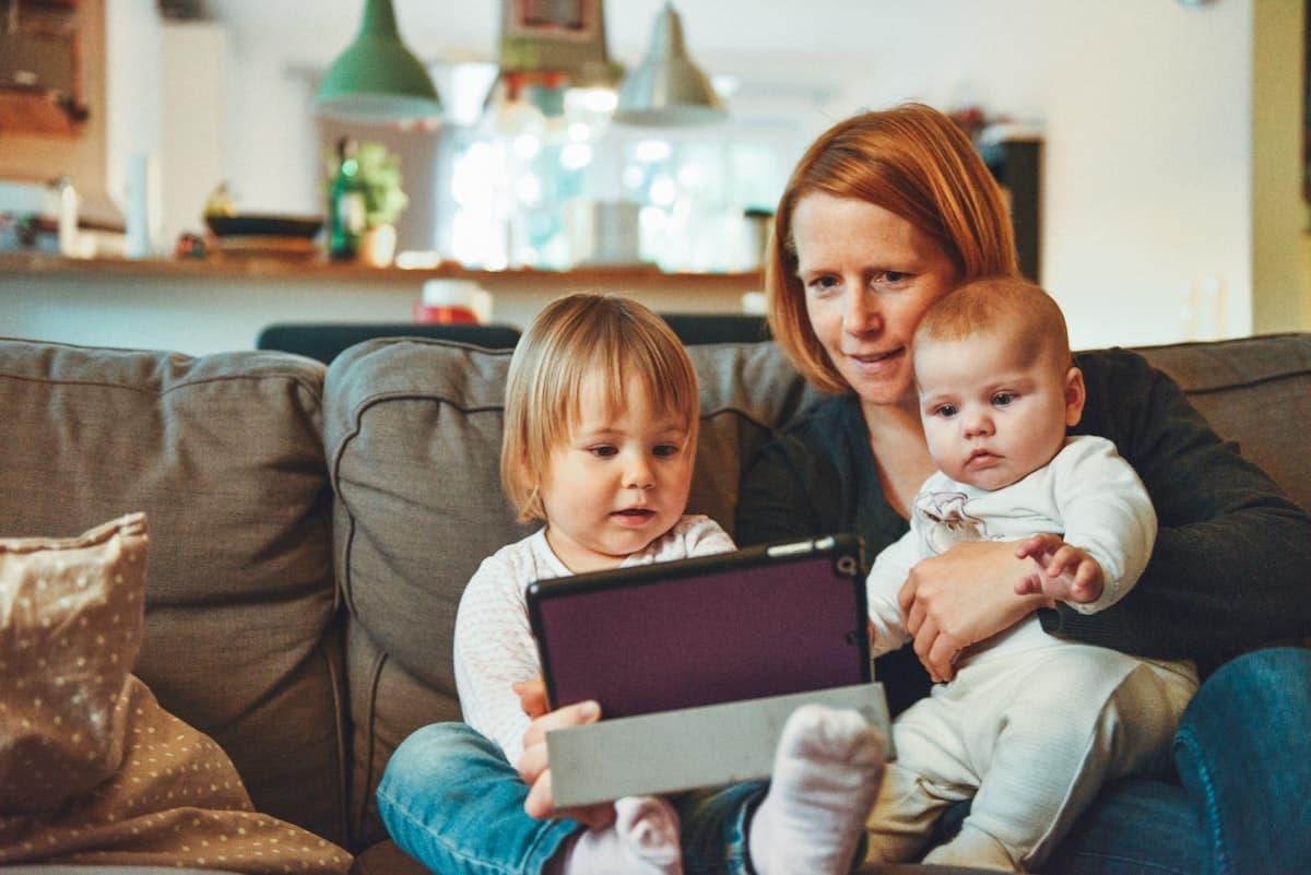 Parent and young kids learning together on the couch